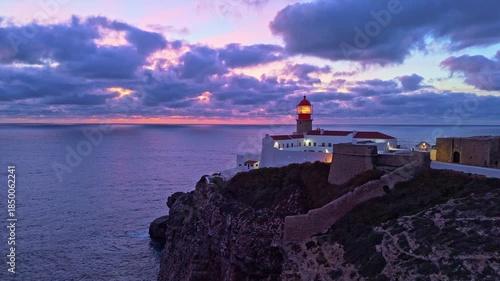 Cape Saint Vincent, Lighthouse, Cliffs and Atlantic Ocean at Evening Twilight. Aerial View. Sagres, Algarve, Portugal. Moving Forward