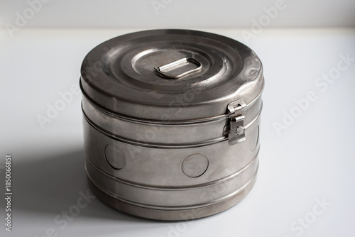 An old medical box is on a white table. Horizontal shot.