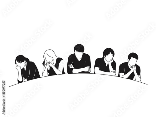 A group of people sit around a table appearing contemplative and subdued