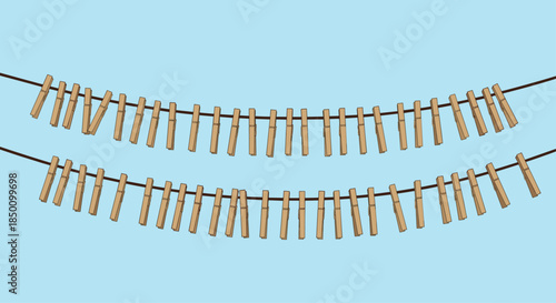 Two parallel rows of wooden clothespins clipped along sturdy ropes stretch across a blue sky creating a playful scene of everyday laundry and rustic charm.