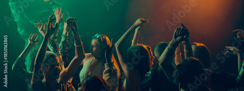 Photos Crowd dancing in dramatic light with raised hands