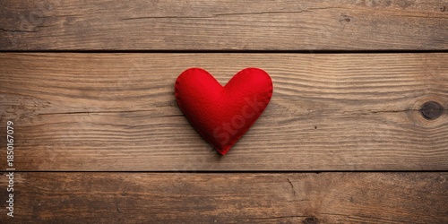 Red felt heart on vintage wood surface designed for Valentine's Day message, suitable as a card background