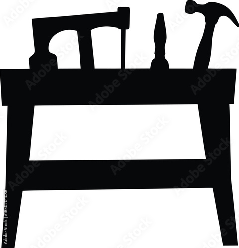 Essential carpentry tools like a hammer and saw resting on a sturdy workbench ready for craft