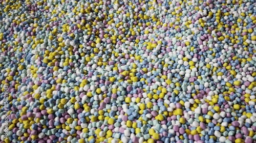 Top view of small multi-colored decorative pebbles background