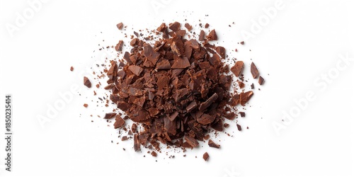 Dark chocolate flakes scattered on a white background, ideal for culinary ingredient displays
