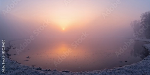 Sunrise over a misty lake w...