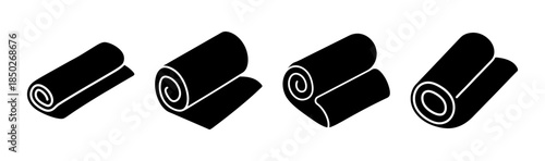 Four black rolls of material or fabric in varying sizes and degrees of unrolling on white background