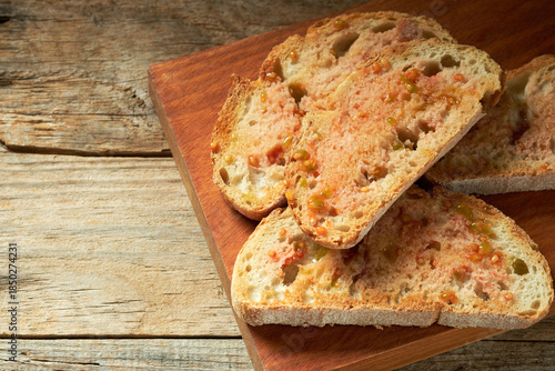 Bread Slices With Tomato and Extra Virgin Olive Oil on a Wooden Board