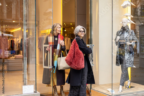 Women exiting modern fashion store after shopping