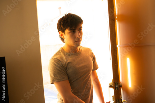 Close up Person Entering Home through Brightly Lit Doorway