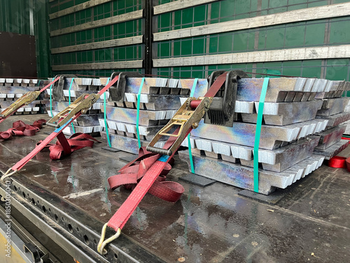 Lead Ingots Secured with Cargo Straps on a Flatbed Truck for Industrial Transportation