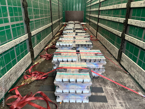 Transportation of Lead Ingots on a Flatbed Truck with Curtain-Side Trailer at an Industrial Warehouse