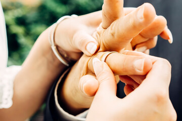 Leinwandbilder Nagelstudio Hand hält goldenen Ehering  © 0990930308