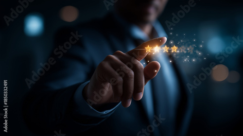Faceless man in suit touching glowing five star rating interface heavily defocused dark background anonymous professional with quality assessment display customer satisfaction