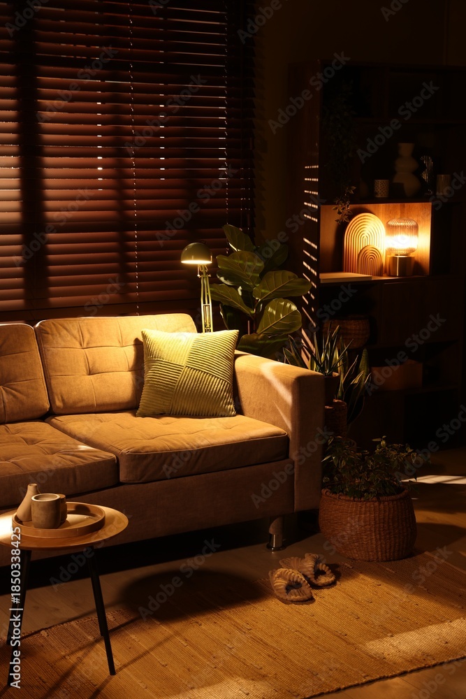 Fototapeta premium Stylish living room with sofa and houseplants. Interior design