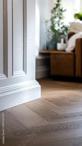 An interior doorway leading into a well-furnished living room with hardwood flooring and modern decor, highlighting a stylish entrance and cozy atmosphere.
