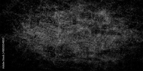 Dark vintage grunge background with a textured black and white abstract pattern featuring aged grey stone and rough concrete surface design for a weathered wall backdrop