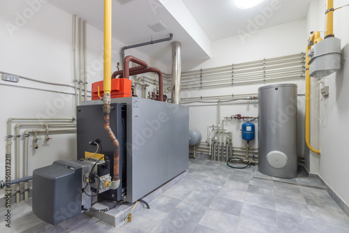 Heating system setup in a utility room with pipes and equipment displayed in a residential building