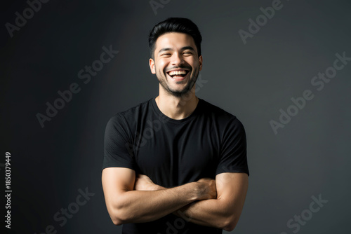 young handsome hicpanic man laughing happily with arms crossed, with a relaxed, positive and satisfied pose