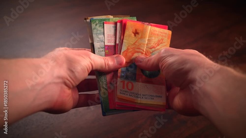 Counting paper money bank notes of swiss francs currency