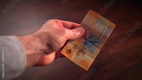 Counting paper money bank notes of swiss francs currency