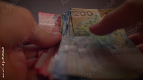 Counting paper money bank notes of swiss francs currency