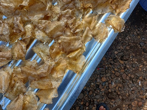Drying raw Jengkol crackers in The Yard