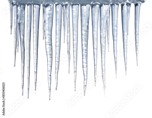 Close-up of clear icicles hanging with a black background, a winter weather phenomenon