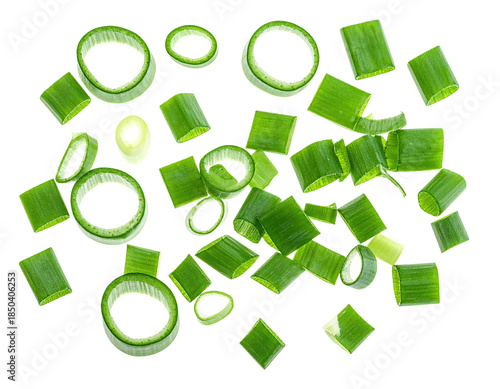 Freshly chopped green onions, a culinary staple, isolated on a stark black background