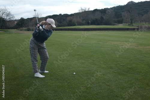 woman playing golf in the green fairway club