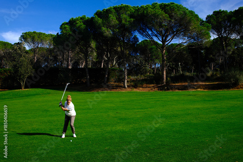 woman playing golf in the green fairway club