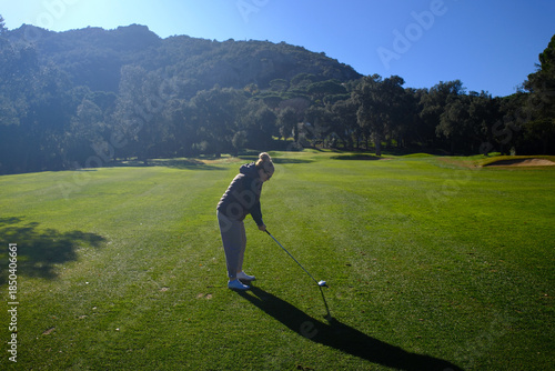 woman playing golf in the green fairway club
