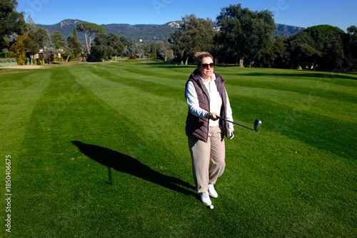 woman playing golf in the green fairway club