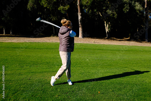 woman playing golf in the green fairway club