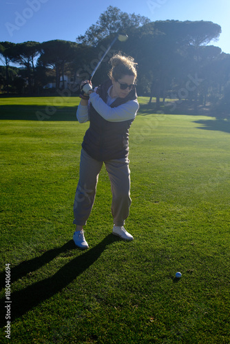 woman playing golf in the green fairway club