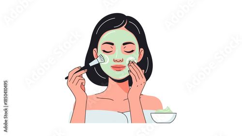 Woman applying a green face mask with a brush