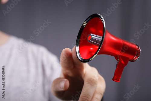 A person is holding a red m...