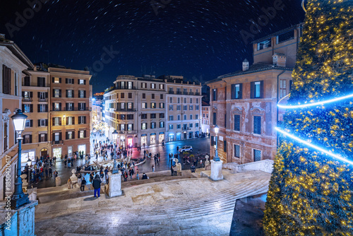 Panoramic view of Piazza di Spagna from the Spanish Steps in Rome, Italy. Taken during the Christmas holidays. Christmas-themed nighttime cityscape.