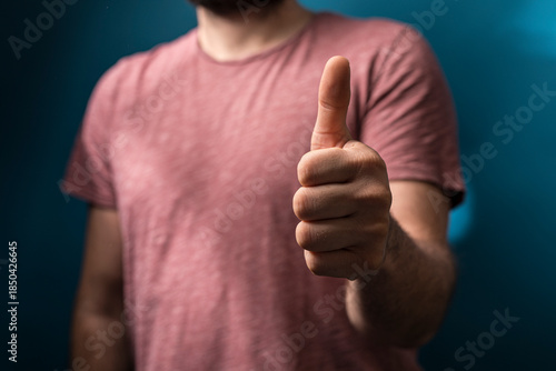 A man in a pink shirt shows...
