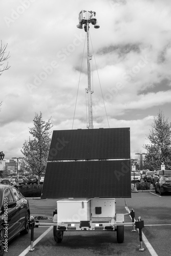 black and white image of a security trailer in a parking lot