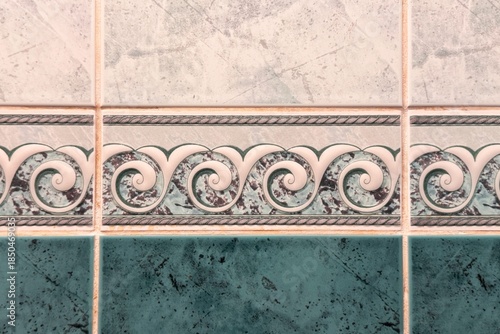 Vintage-style ceramic tiles featuring teal marble texture and ornate wave border pattern.