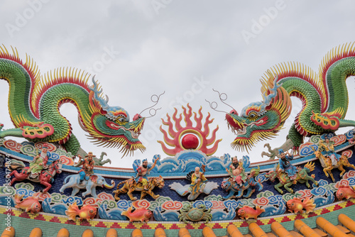 Colorful Chinese dragon sculptures and figures of deities and immortals adorn the intricate ridge of a temple roof nearthe Zhengbin Fishing Port in Keelung, Taiwan.