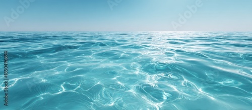 Tranquil Turquoise Ocean Water Sparkling Under Bright Blue Sky