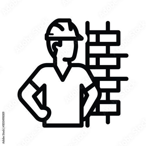 Construction worker standing near brick wall