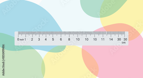 Ruler with inch and centimeter markings on a colorful abstract background