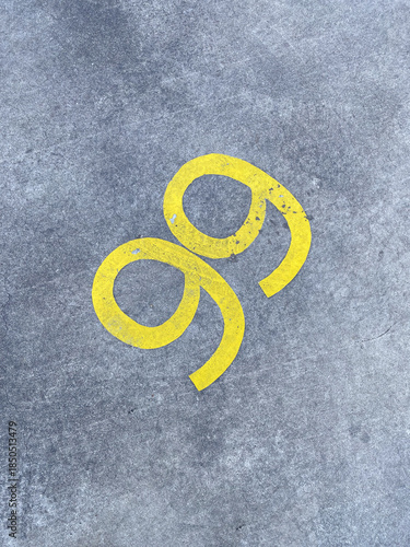 Yellow Marking on Gray Concrete Surface with Unique Curvy Design