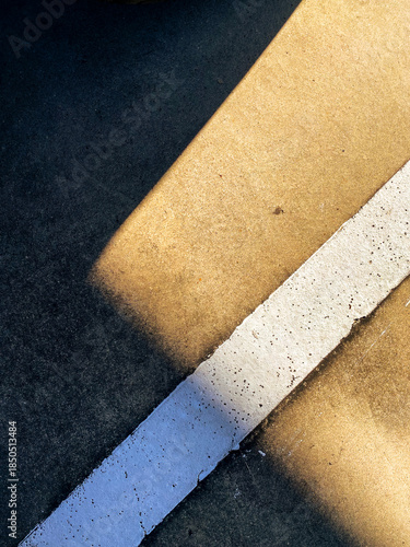 Abstract Close-Up of Concrete Surface with White Line and Shadow