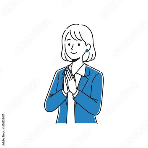 A businesswoman in a blue blazer standing with hands clasped together in a gesture of gratitude or respect.