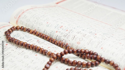 The Holy Quran, with prayer beads and white background. Islamic Concept