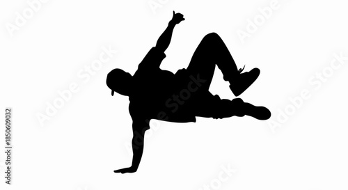 Silhouette of a breakdancer performing a dynamic freeze move.